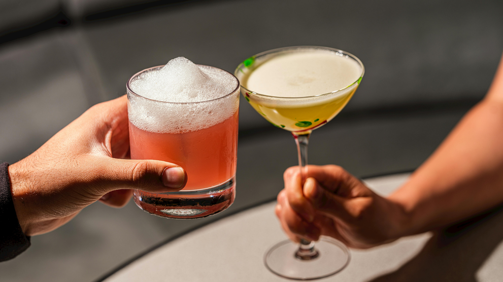 Guests toasting with craft nonalcoholic cocktails at a party.