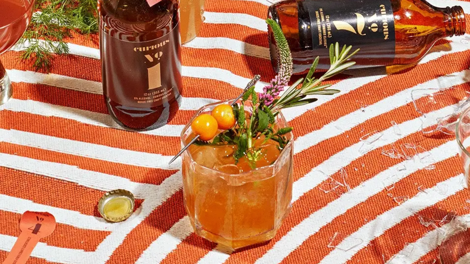 Trying Curious Elixirs cocktails on a vibrant picnic setup.
