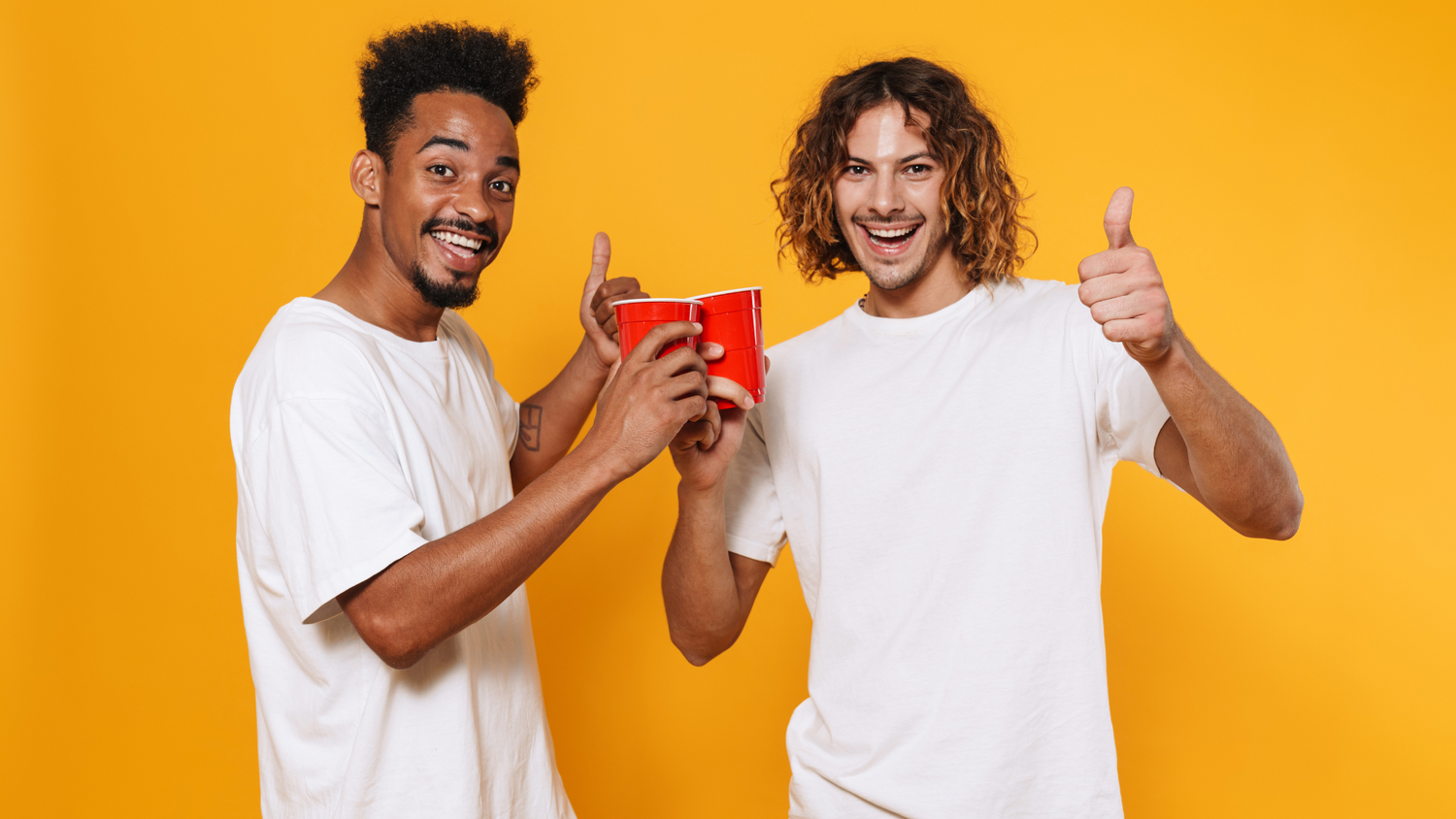 Two men toasting cups, celebrating a nonalcoholic drink choice