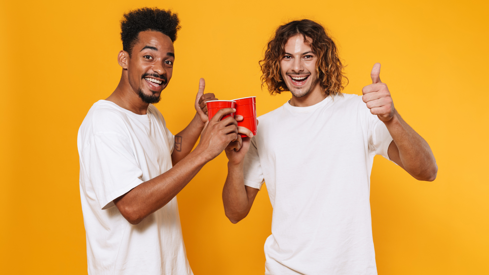 Two men toasting cups, celebrating a nonalcoholic drink choice