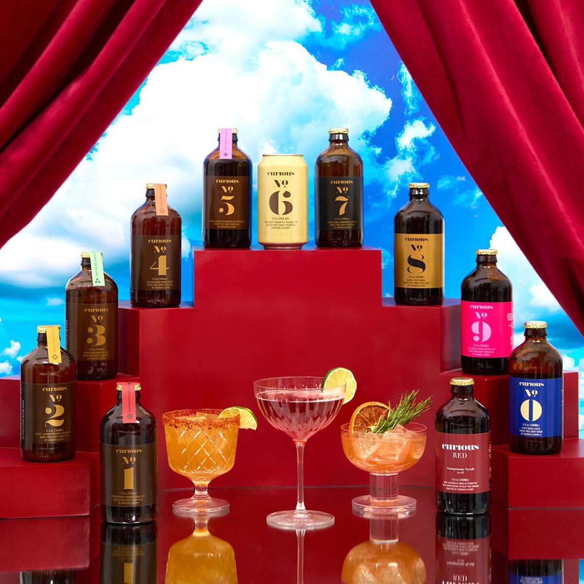 Curious Elixir Bottles on red stairs revealed through a red curtain with a cloudy background 