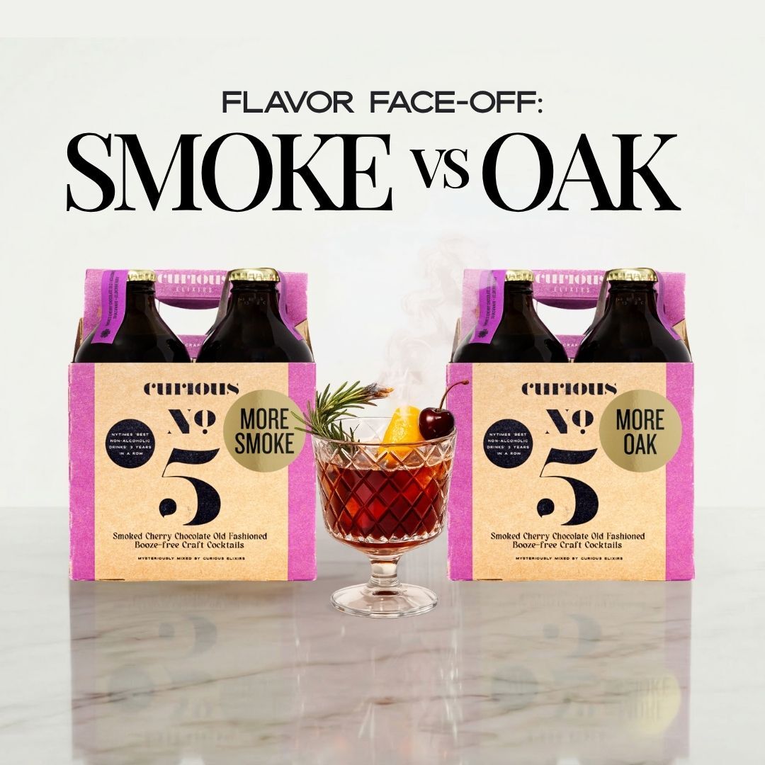 Two packs of Curious No 5 with 'More Smoke' and 'More Oak' labels, accompanied by a cocktail on a marble surface.