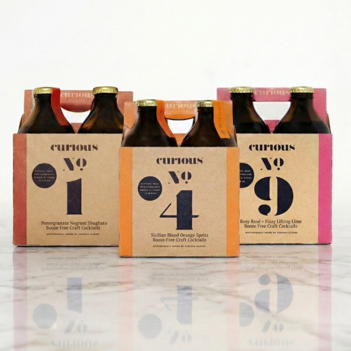 Three Curious Elixirs 4-packs displayed side by side, with No. 1 on the left, No. 4 in the center, and No. 9 on the right.