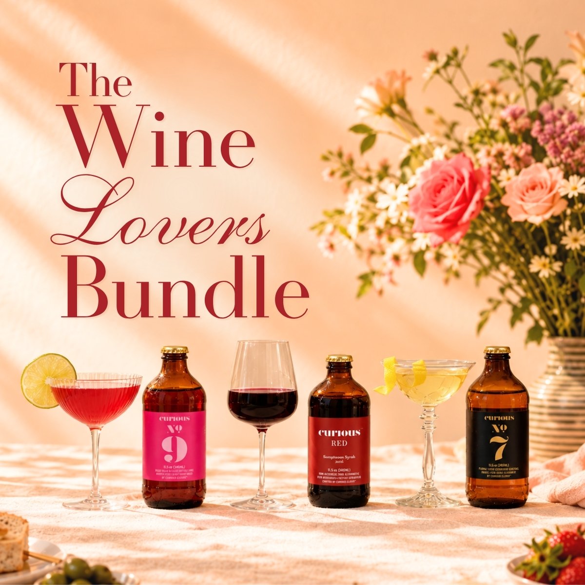'The Wine Lovers Bundle' featuring three Curious bottles, Curious No. 9, Curious Red, and Curious No. 7, and three wine glasses on a table, with a floral arrangement in the background under warm sunlight.