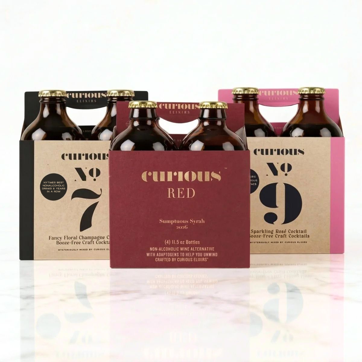 Wine Lover bundle 3 4-packs with four bottles in each carrier, featuring Curious No. 7, Curious Red, and Curious No. 9 on a marble counter with a white background.