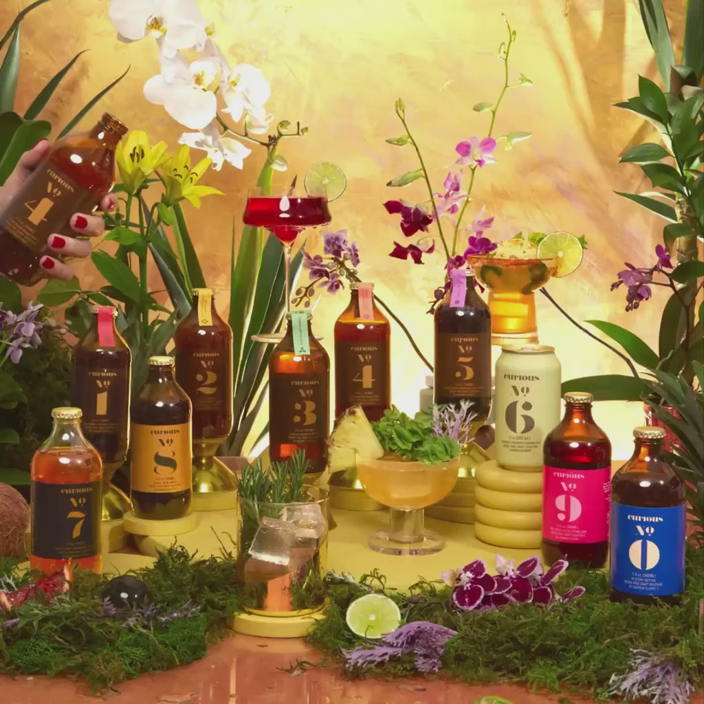 All Curious Elixirs Gif with a person pouring Curious No. 4 into a garnished glass